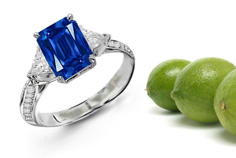 Richly Embellished: 3 Stone Trillion Diamond Emerald Cut Sapphire Ring