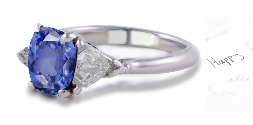 Trademark Style: 3 Stone Oval Sapphire & Shield Bullet Diamond 2 Side Gemstones Ring