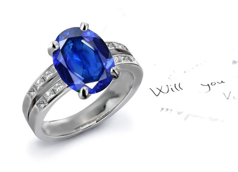 Continues To Resonate: Oval Fine Blue Sapphire & Side Stone Matched Princess Cut Diamond Split Shank Sapphire Ring