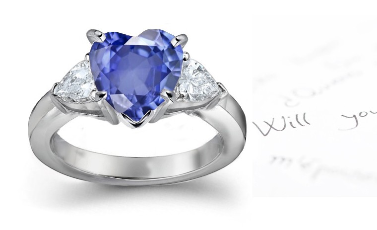 Deep Dark Blue in Color: Heart Shaped Fine Blue Sapphire & Pear Shape Sparkling Diamond Three Stone Platinum Ring