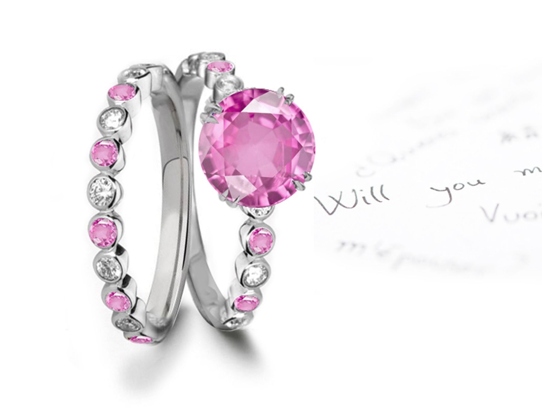 A timeless, design with a deep pink 1.0 carat round sapphire & halo of well-cut White Diamonds & sapphires in bridal set