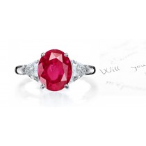 Classic Ruby Ring: Platinum ruby oval and diamond trillions three stone engagement ring