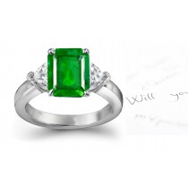 A Three Stone Heart Diamond & Emerald Cut Emerald Ring Crafted in Platinum Creating Extraordinary Visionaryl Experience