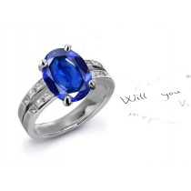 Continues To Resonate: Oval Fine Blue Sapphire & Side Stone Matched Princess Cut Diamond Split Shank Sapphire Ring
