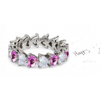 Heart Shaped Diamond Prong Set Diamond & Pink Sapphire Eternity Rings in Gold