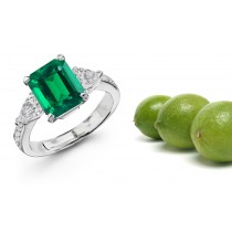Matched or Graduated: Center Emerald Cut Emerald & Pear-shaped Brilliant Diamond Side Stones Three Stone Ring
