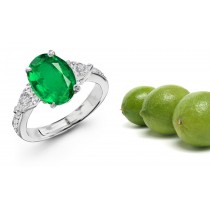 Three Stone Diamond Rings Features Center Oval Cut Emerald, and pear-shaped side stones
