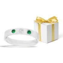 Emerald Rings: Classic Tiffany Style Emerald and Diamond Rounds Tiffany Style Burnish Set Rings in Platinum. 