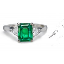 Carried in Stock: A long & ThinClassic 3 Stone Splendid Emerald Cut Emerald with Parallel Lines & Pyramid Trillion Diamond Ring in Enduring Platinum
