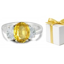 Oval Yellow Sapphire with Trapezoid Diamonds in 14k White Gold Engagement Ring (7x5 mm)