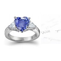 Deep Dark Blue in Color: Heart Shaped Fine Blue Sapphire & Pear Shape Sparkling Diamond Three Stone Platinum Ring