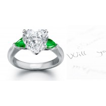 Elegant New Styles: Platinum Pear-shaped Center Emerald & Diamond Heart side stones in plain platinum mountings 3 Stone Ring