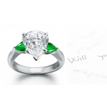 Special Designs: Half Hoop, three stones in plain platinum mounting Center pear-shaped Emerald & Diamond pear-shaped sides 