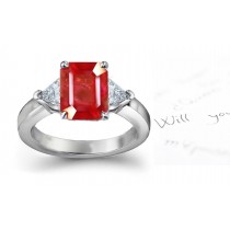 Ruby Three Stone Engagement Rings: Platinum ruby ring with center octagon ruby and diamond trillions on side.