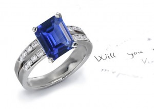 Intrinsic Value: A Perfect Split Shank Emerald Cut Fine Blue Sapphire & Round Signifying Diamond Fashion Ring in Gold