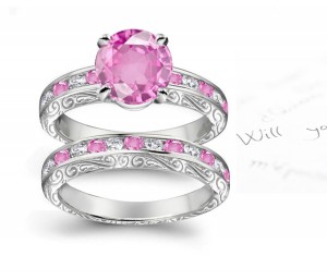 A timeless, design with a deep pink 1.0 carat Splendid Sapphire & halo of well-cut White Diamonds Splendid Sapphires in Platinum & Gold